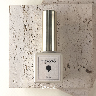 Elegant and innovative Riposo magnetic gel nail polish bottle showcasing the captivating 'Sandy Beach Collection' against a textured concrete backdrop. This high-performance, one-step powder gel product simplifies the nail art process for effortlessly beautiful results.