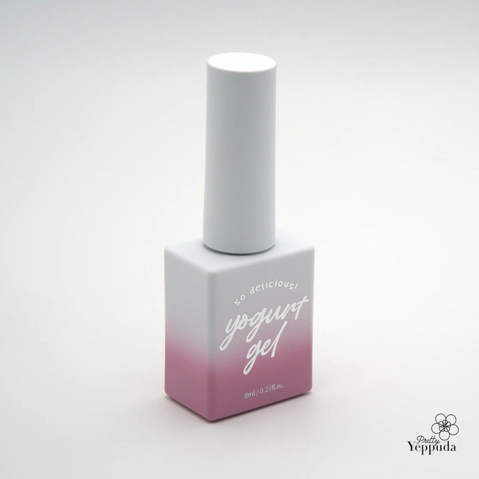 Twelve natural syrup nail gel polish bottles from the Yogurt Blossom Ending Collection, featuring a sleek and modern ombre design and compact packaging for easy storage and application. The gel formula offers medium viscosity, self-leveling properties, and seamless blending with the natural tone of the nails.