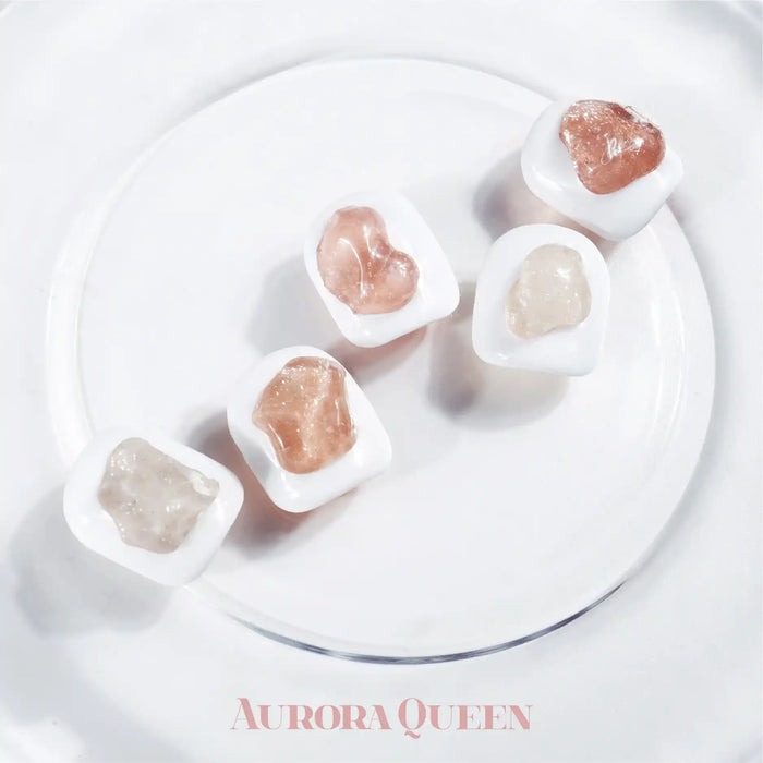 An image displaying a set of eight glitter gels in various mellow hues, including creamy, muted, ripen, mauve, fig, mocha, persimmon, and acorn shades. The product is titled "AURORA QUEEN Mellow Set" and the image showcases the vibrant, yet subdued color palette of the gel collection on a clean, minimalist background.