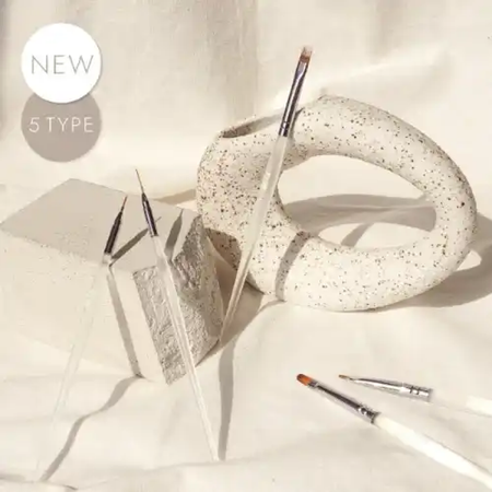 Elegant nail brush set including liner brushes, round brush, check brush, and gradation brush, all housed in a complementary leather case, designed for controlled gel application by both beginners and professionals. DGEL x JINI Nail Studio collaboration.