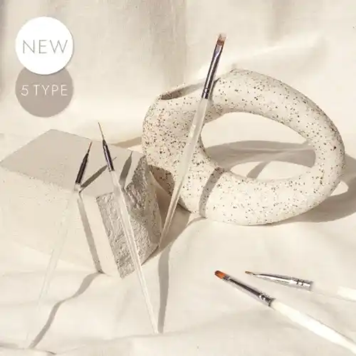 Elegant nail brush set including liner brushes, round brush, check brush, and gradation brush, all housed in a complementary leather case, designed for controlled gel application by both beginners and professionals. DGEL x JINI Nail Studio collaboration.