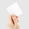 A large, white, square-shaped Jello Jello branded easy gel wipes package being held in a person's hand against a plain white background, showcasing the product's compact and convenient design for effective lint-free cleaning.