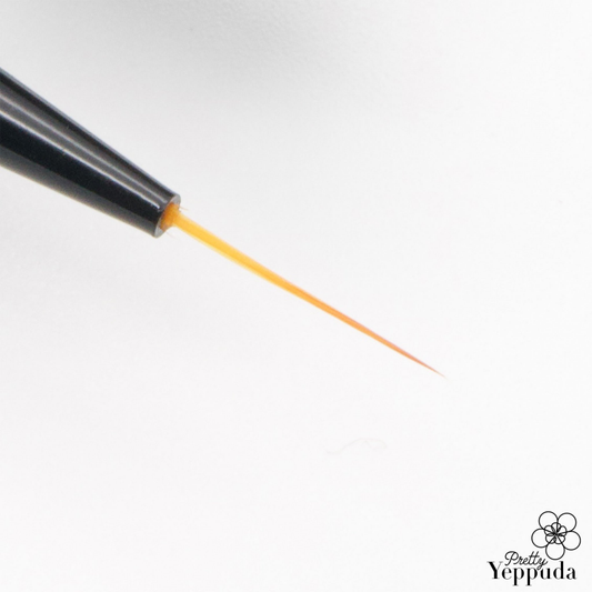 A close-up shot of a black JELLO JELLO Flexible Brush, its supple bristles gently curving as they release a vibrant orange paint, showcasing the dynamic versatility and expressive capabilities of this premium art supply from the JELLO JELLO brand.