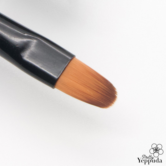 Flexible, oval-shaped makeup brush from the JELLO JELLO brand, designed to precisely apply and blend gel nail polish for a flawless, professional-looking manicure.