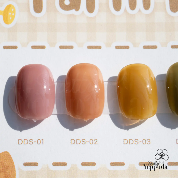 A vibrant display of six rolling bottles in a variety of pastel shades, showcasing the JIN.B Ding Gading collection. The image highlights the diverse color options, including soft pinks, oranges, and yellows, providing a visually appealing and organized presentation for this Shopify product line.