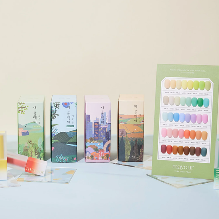 The alt text for the image could be:
"A colorful display showcasing MAYOUR The Collector Season 2 gel polish set, featuring 40 semi-sheer lacquers in a variety of seasonal hues. The product packaging and display highlight the versatility, quality, and artistry of this premium nail care brand.