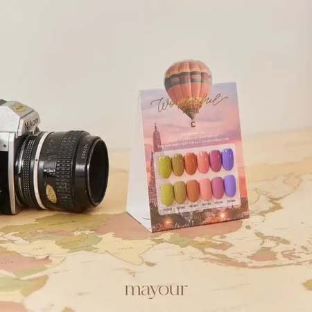 A vibrant hot air balloon against a warm-hued sky, showcasing the colorful nail polish shades of the MAYOUR Wonderful Flying Collection, capturing the essence of whimsical adventure and creativity.