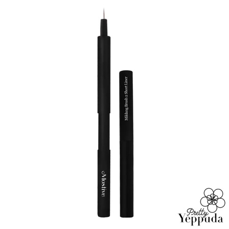 This image depicts a sleek, retractable makeup brush by Mostive, a Shopify product, designed with a push mechanism to conveniently store the brush. The brush is a Short Liner 0.4, allowing for precise and controlled application of cosmetics. The minimalist, black design exudes a modern and professional aesthetic, making it a stylish addition to any beauty routine.
