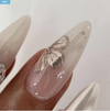 A close-up photograph of an elegant, beautifully manicured nail featuring a striking butterfly design in shimmering gold and pink hues. The nail polish appears to be a high-quality gel product from the renowned Korean nail brand NAILBAYO, as described in the product details. The intricate butterfly motif adds a touch of whimsical charm and glamour to this carefully crafted nail art.
