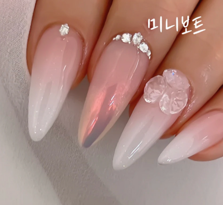 A delicately crafted, pearly pink nail set featuring intricate floral designs, showcasing the refined and luxurious Nailbayo brand aesthetic.