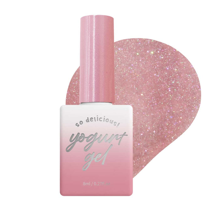 Delicate, sparkling pink nail polish bottle with soft gel formula and reflective effect, designed for the Yogurt Ballerina 1 Collection. The product features a mid-viscosity formula that self-levels and blends seamlessly with the natural tone of the nails, creating a polished and vibrant look.