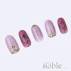 Elegant and ornate nail art stickers featuring gold-edged jewels on a soft pink backdrop, allowing for easy creation of luxurious, jewel-inspired nail designs. Tsumekira NOBLE JEWELRY's NO-JEW-101 collection offers a high-quality, versatile nail art solution for gel manicures.