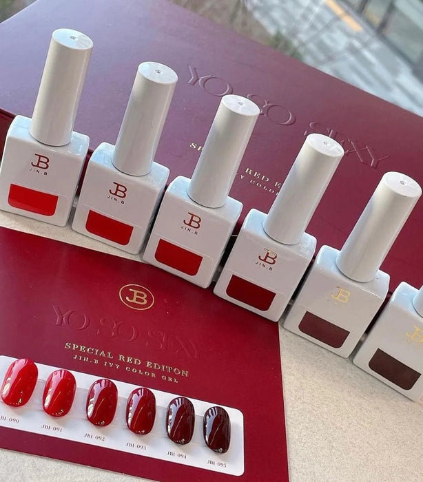 Vivid red nail polish bottles arranged neatly on a red background with the product title "JIN.B IVY Yo So Sexy 6pc Collection" prominently displayed. The set showcases a special limited edition of 6 different shades of red, perfect for creating bold and alluring nail looks. This image effectively highlights the key features of the Jin.B brand's high-quality, long-lasting gel nail polish collection.