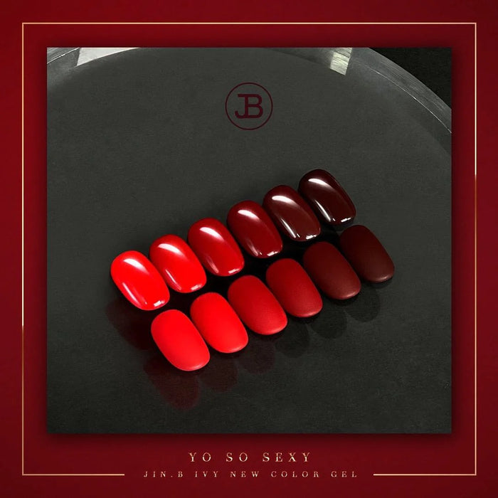 A carefully arranged collection of Jin.B IVY brand nail polish bottles in a bold, sexy red color scheme, displayed on a dark background with the brand logo visible.