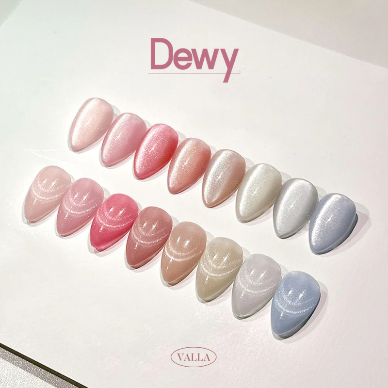 Detailed image of the VALLA Dewy Collection, showcasing a variety of shimmering, glossy nail polish shades in pastel and nude tones, arranged in a fan-like display to highlight the brand's new magnetic gel polish series with a silky, smooth cat-eye effect. The image emphasizes the trendy and high-quality nature of the product, which is available in a full set or as individual gels.