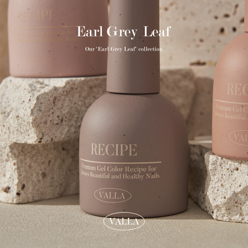 Close-up of three VALLA Earl Grey Leaf collection nail polish bottles in soft earth tones, positioned against a backdrop of natural stone. The image emphasizes the premium quality and subtle elegance of the gel colors.