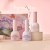 Elegant spring-themed display showcasing the VALLA Spring Day Collection, featuring a variety of pastel-colored gel nail polishes and a glitter gel, set against a soft, floral backdrop. The vibrant and warm colors evoke the feeling of the new spring season.