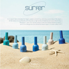 Colorful gel nail polishes from the VALLA Surfer Collection on a sandy beach, with starfish and ocean waves in the background, showcasing the brand's ocean-inspired nail care products.