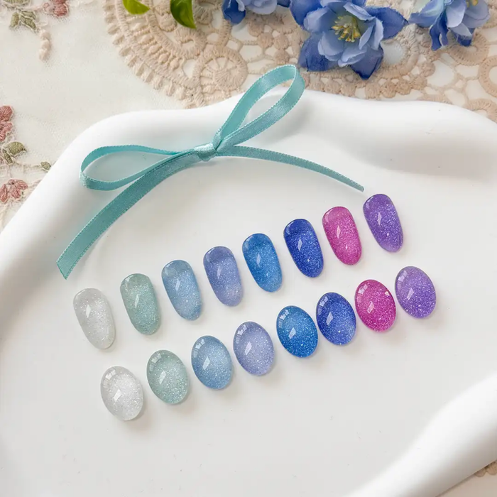 Elegant iridescent nail polish colors in shimmering shades of blue, green, pink, and white, showcasing the vibrant Ballerina 2 Collection by the Shopify brand, YOGURT.